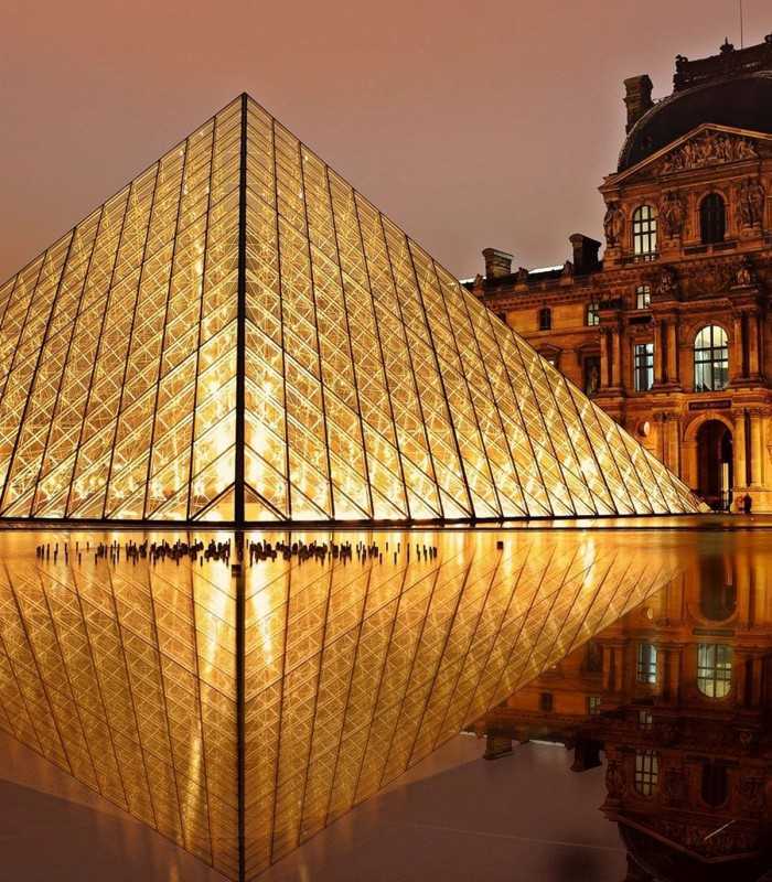 Louvre Museum glass pyramid illuminated at night in Paris, seen during a private evening tour.