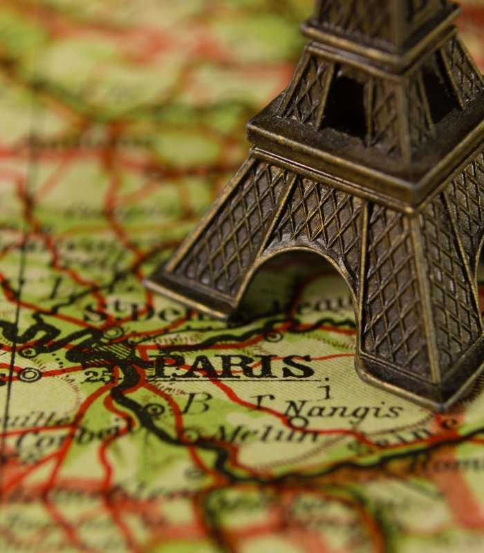 Replica of the Eiffel Tower marked on a Paris map, France, ideal for planning private Paris tours