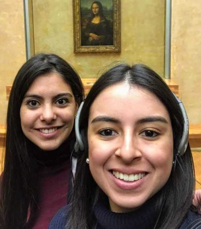 Young visitors taking a selfie with the Mona Lisa during a private Louvre tour