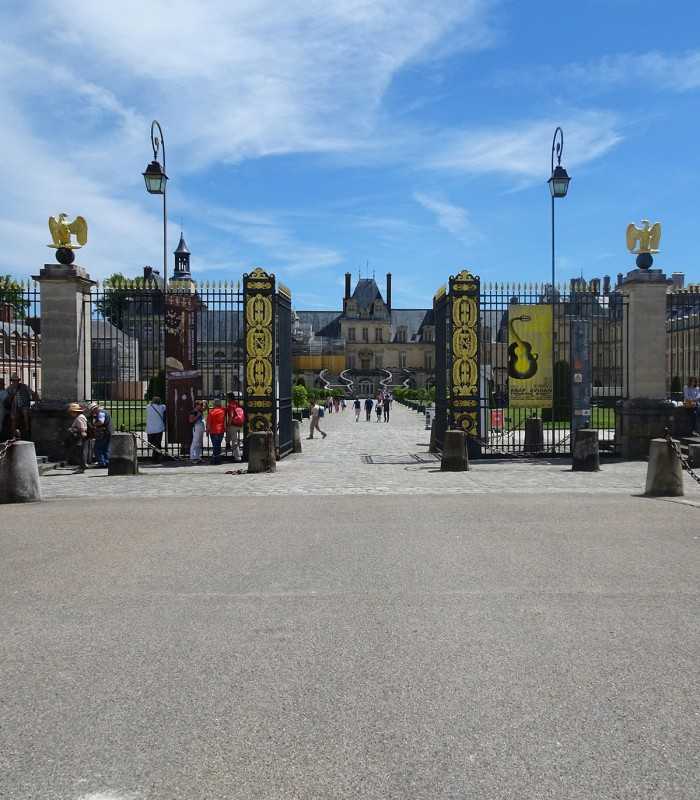 At the entrance of Fontainebleau Castle with a private driver and guide