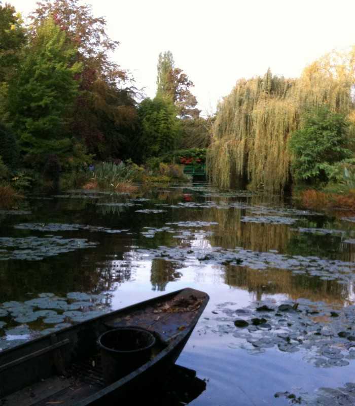 Private Giverny tour showcasing barges on Monet’s pond, used for garden maintenance and water lily care