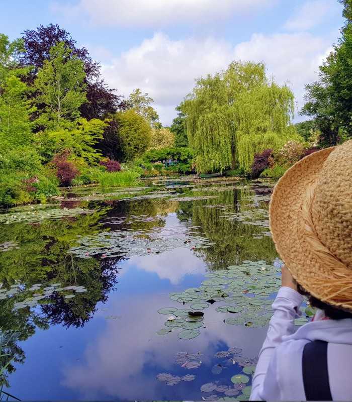 Client contemplating Monet’s water lily pond in Giverny during a private tour from Paris