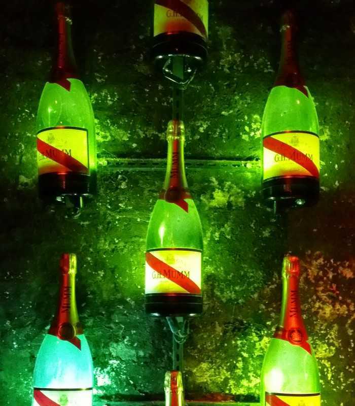Rows of Mumm bottles displayed in historic Reims cellars during a private Champagne experience