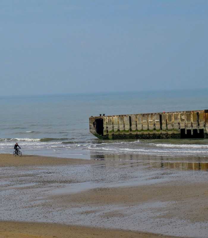Arromanches Gold beach with Mulberry Harbour concrete blocks remains on a guided D-Day tour from Paris