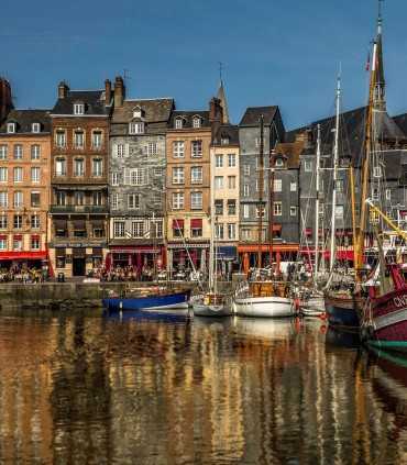 Honfleur old harbor with colorful houses during a private day tour from Paris