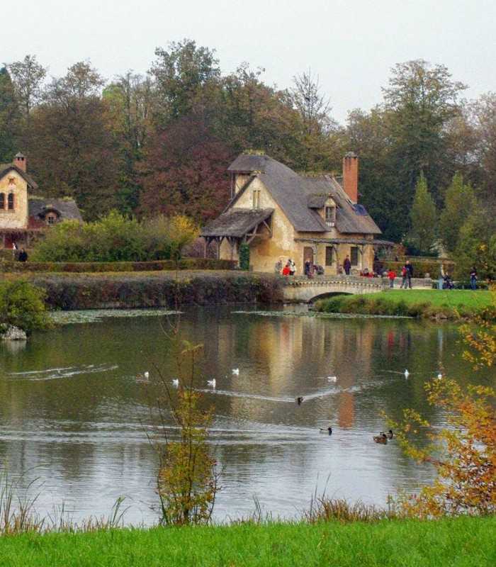 Marie Antoinette’s Hamlet at Versailles with rustic cottages on a private tour from Paris