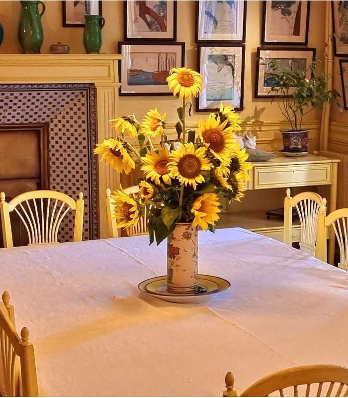 Sunflowers in a vase in Monet’s Giverny dining room, highlighting his favorite yellow, during a private tour